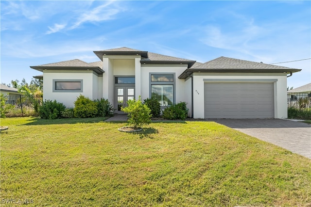 prairie-style house with a garage and a front lawn