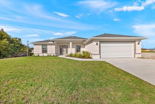 view of front facade with a garage and a front lawn