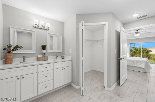 bathroom with ceiling fan and vanity