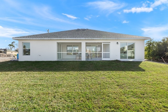 back of house with a lawn