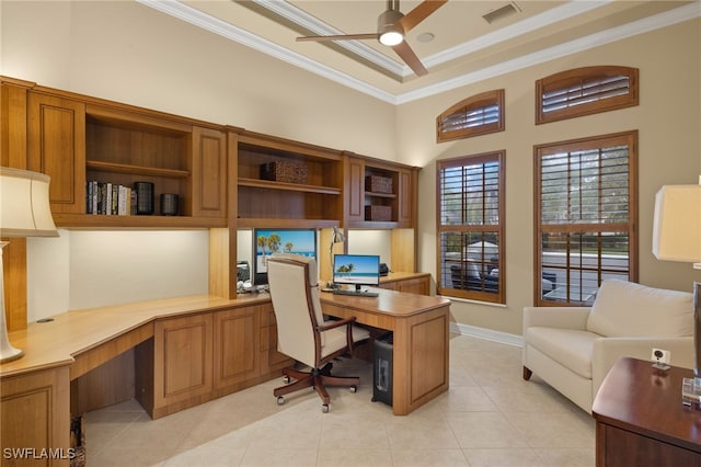 home office with built in desk, crown molding, light tile patterned flooring, and a high ceiling