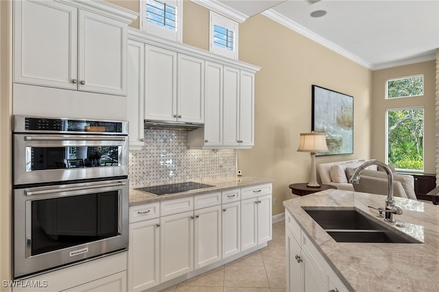 kitchen with white cabinetry, black electric cooktop, crown molding, sink, and stainless steel double oven