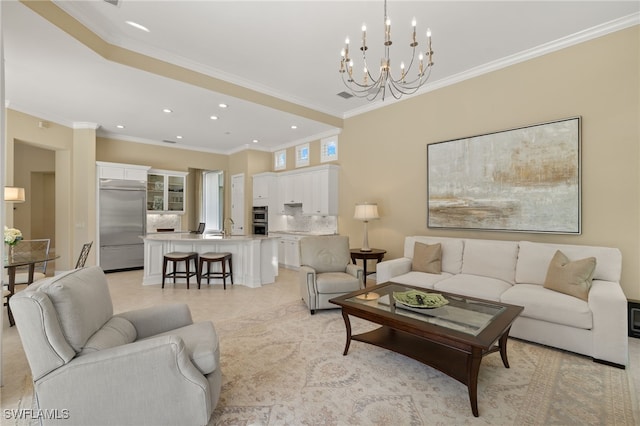 living room with ornamental molding, sink, and a chandelier