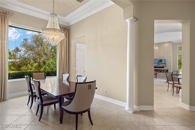 dining room with a notable chandelier, light tile patterned flooring, and decorative columns