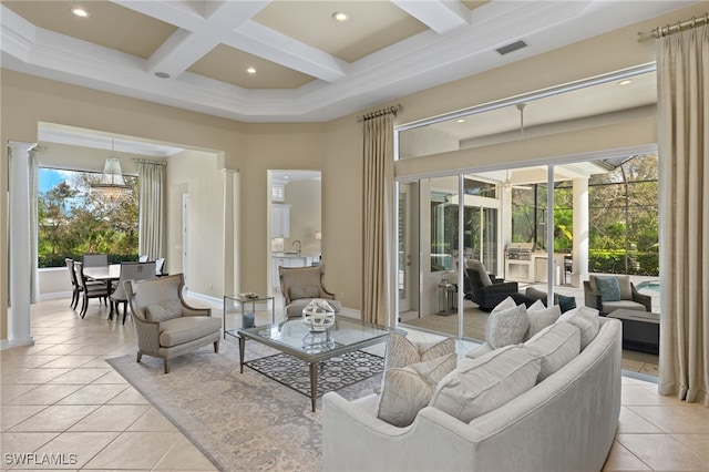 tiled living room with a healthy amount of sunlight, beamed ceiling, coffered ceiling, and decorative columns