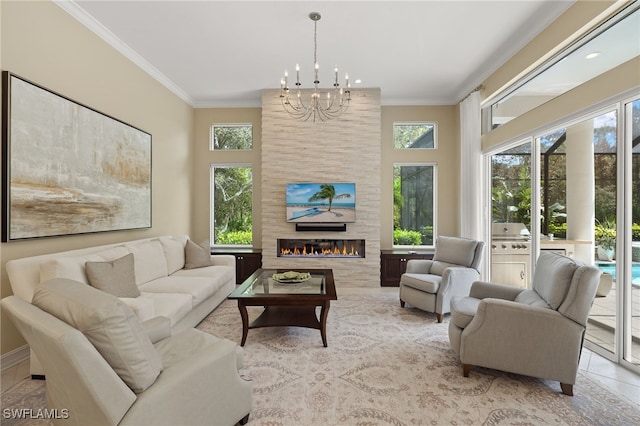 living room with a large fireplace, ornamental molding, light tile patterned floors, and a chandelier