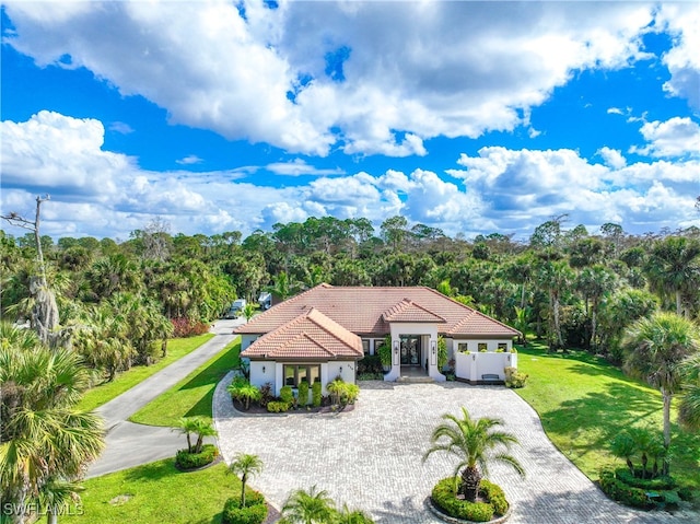 mediterranean / spanish-style home with a front lawn