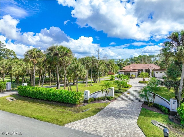 view of property's community with a lawn