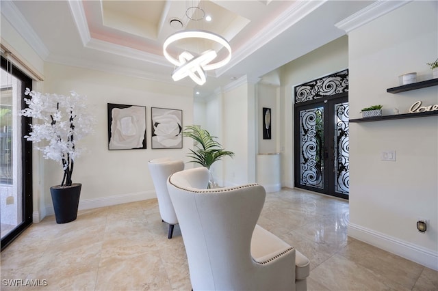 dining space featuring french doors, ornamental molding, a raised ceiling, and a chandelier