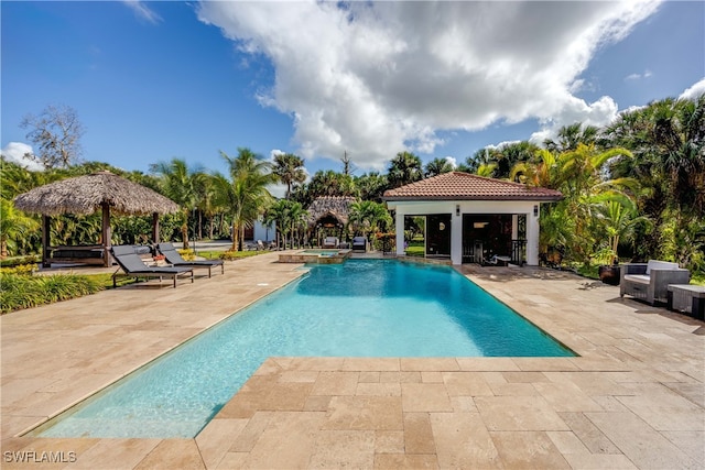 view of swimming pool with a gazebo, a patio area, and an in ground hot tub