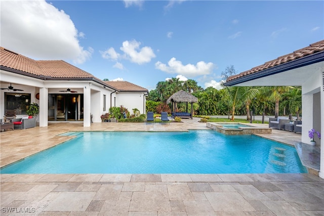 view of swimming pool featuring an in ground hot tub, ceiling fan, a gazebo, and a patio area