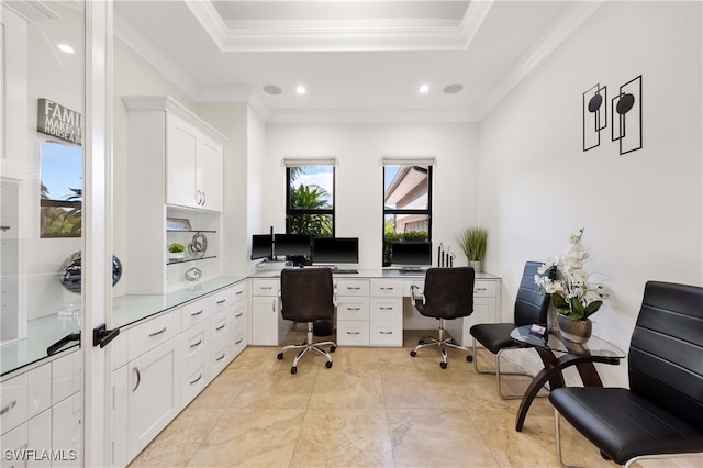 office area with a raised ceiling and ornamental molding