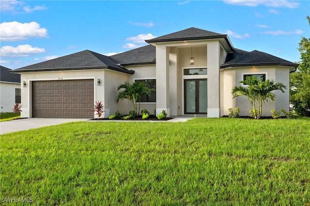 prairie-style home with an attached garage, stucco siding, french doors, and concrete driveway