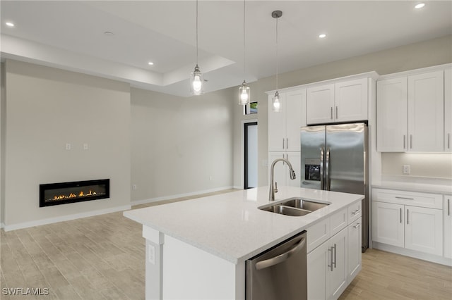 kitchen featuring light wood-style floors, a sink, appliances with stainless steel finishes, and recessed lighting