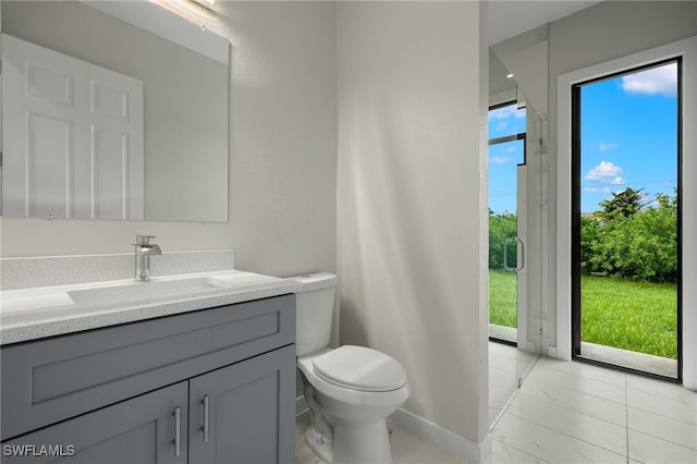 bathroom with vanity, toilet, and marble finish floor