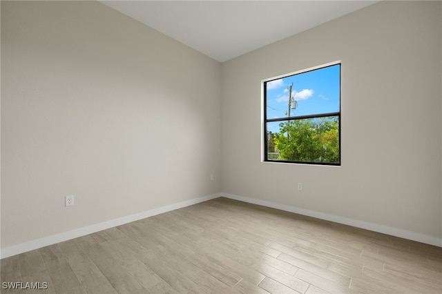 empty room with light hardwood / wood-style flooring