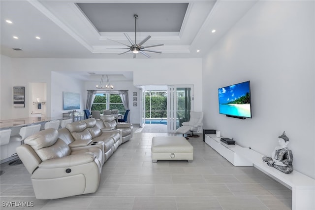 living area featuring recessed lighting, a ceiling fan, a towering ceiling, a tray ceiling, and light tile patterned floors