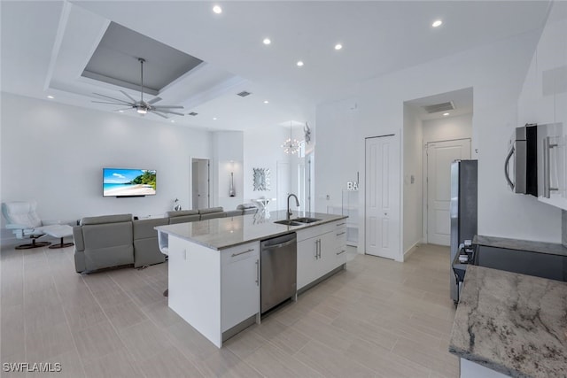 kitchen featuring appliances with stainless steel finishes, white cabinetry, recessed lighting, a center island with sink, and open floor plan