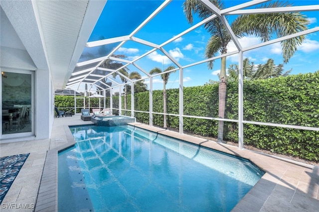 view of pool with glass enclosure, a patio area, and a pool with connected hot tub