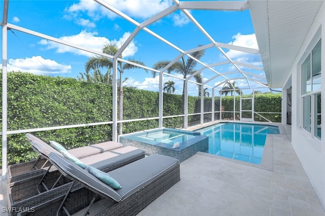 view of swimming pool featuring a patio area, a pool with connected hot tub, and glass enclosure