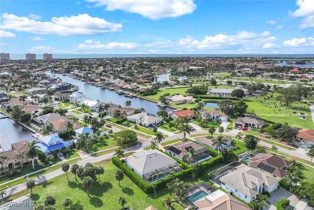 birds eye view of property with a water view and a residential view