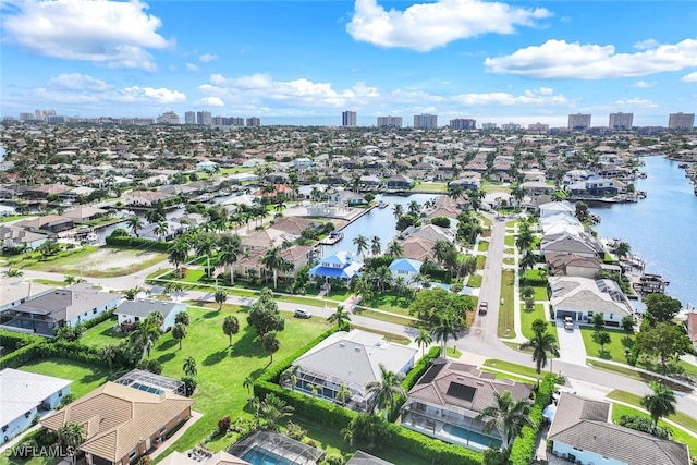 aerial view of residential area featuring a large body of water and a view of skyline