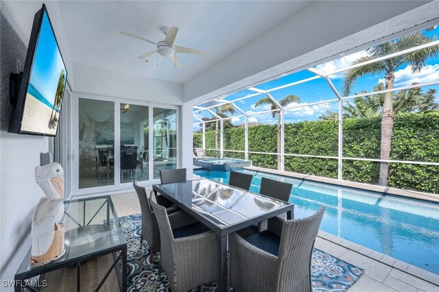 sunroom / solarium featuring a ceiling fan, a pool, a jacuzzi, and outdoor dining space
