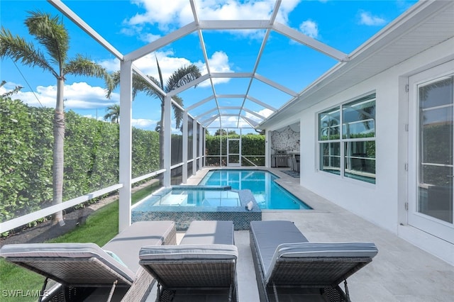 view of swimming pool featuring a patio area, a pool with connected hot tub, a lanai, and area for grilling