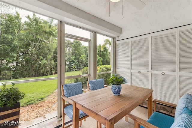 sunroom featuring ceiling fan