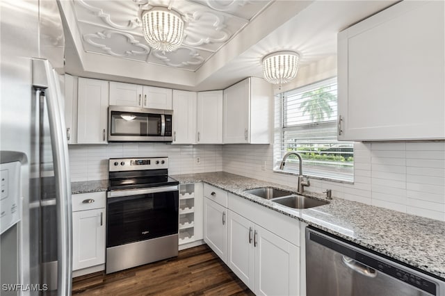 kitchen featuring stainless steel appliances, white cabinetry, and sink