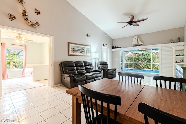 tiled dining area with ceiling fan, a healthy amount of sunlight, and high vaulted ceiling