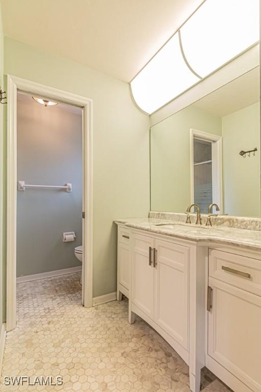 bathroom featuring toilet and vanity