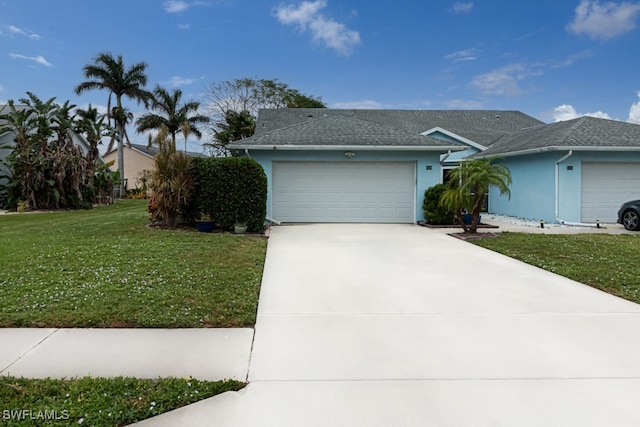 ranch-style house featuring a front yard and a garage