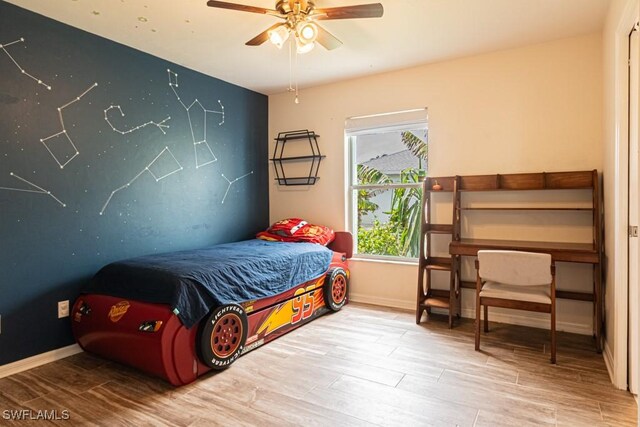 bedroom featuring hardwood / wood-style flooring and ceiling fan