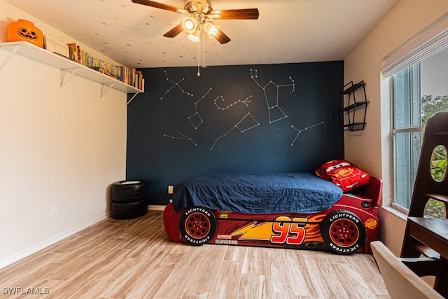 bedroom with ceiling fan and wood-type flooring