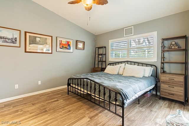 bedroom featuring lofted ceiling, hardwood / wood-style flooring, and ceiling fan