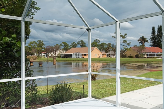 unfurnished sunroom featuring a water view