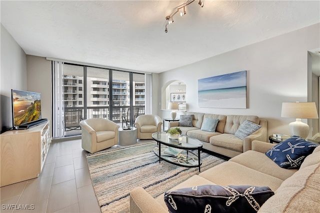 living room with light tile patterned flooring and expansive windows