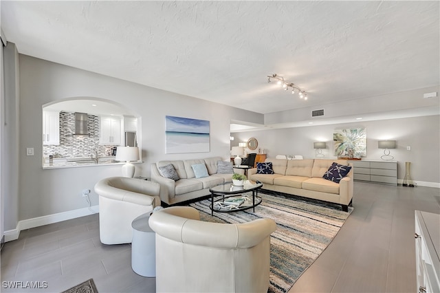 tiled living room with a textured ceiling