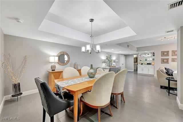 dining area with an inviting chandelier