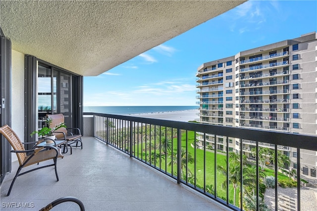 balcony with a view of the beach and a water view