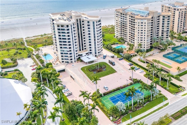 bird's eye view featuring a water view and a beach view