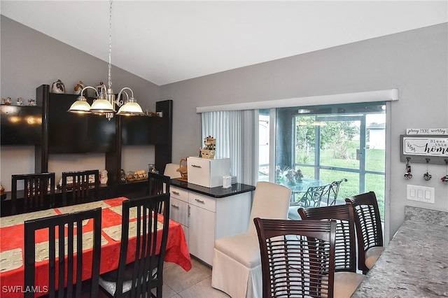 kitchen with lofted ceiling, hanging light fixtures, light tile patterned floors, white cabinetry, and a chandelier