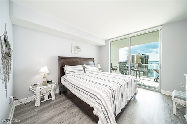 bedroom featuring access to exterior and hardwood / wood-style flooring