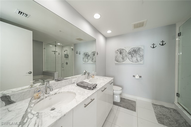 bathroom with tile patterned floors, toilet, a shower with door, and vanity