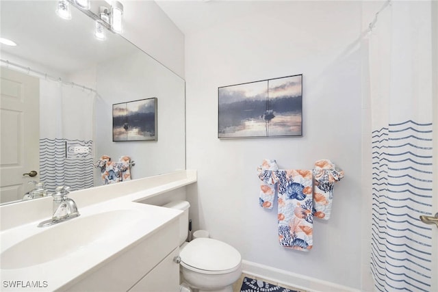 bathroom featuring vanity and toilet