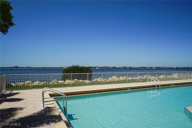 view of swimming pool with a water view