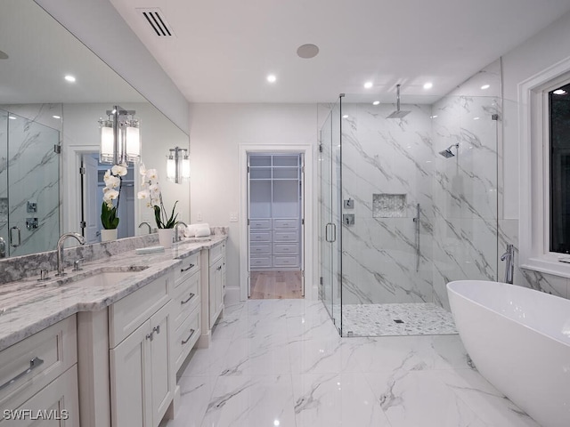 bathroom featuring vanity and independent shower and bath