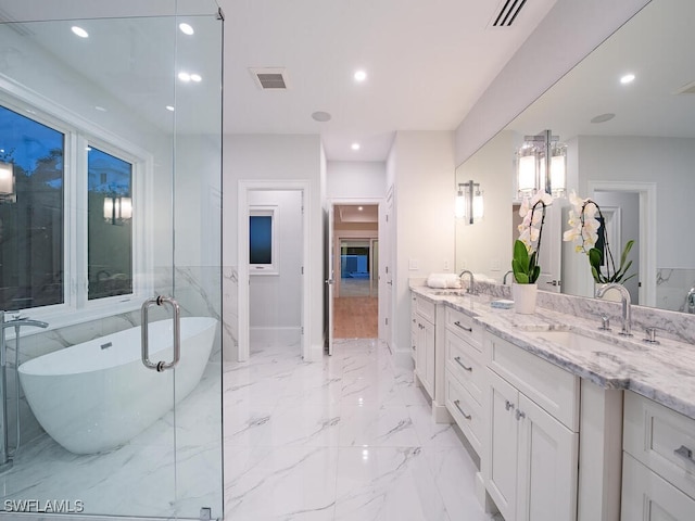 bathroom with vanity and a tub to relax in