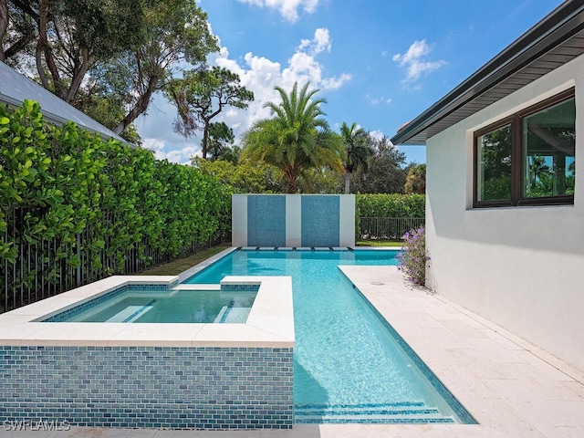 view of swimming pool with an in ground hot tub